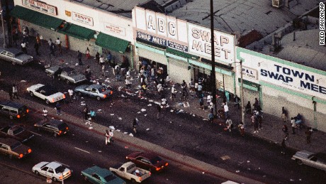 Looters go in and out of a swap meet in South Central Los Angeles on Wednesday, April 29, 1992.