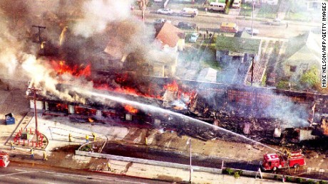 A fire department crew sprays water on a burning mini-mall in south Los Angeles on April 30,1992 after a night of rioting.