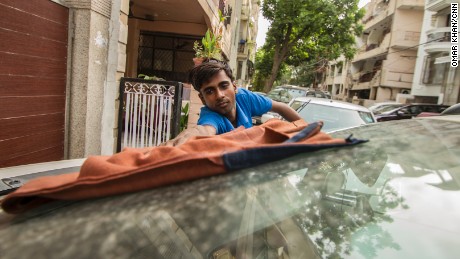 Shambhu still washes cars every morning to help his family earn a living. 