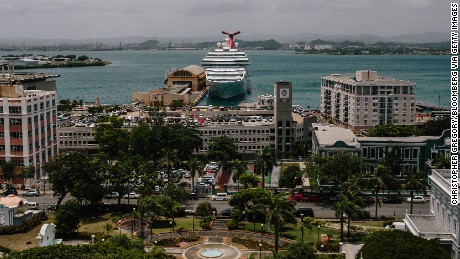A cruise ships sits docked past the Old City of San Juan, Puerto Rico, on Wednesday, July 8, 2015. A growing number of Republicans in the U.S. Congress are saying they want to support Puerto Rico as it wrestles with an escalating debt crisis, though they've stopped short of backing legislation allowing for municipal bankruptcy. Photographer: Christopher Gregory/Bloomberg via Getty Images