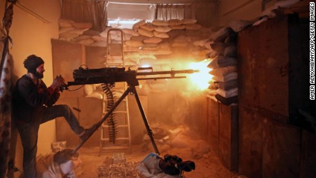 An opposition fighter fires a  machine gun in Jobar, a rebel-held district outside Damascus, in March.