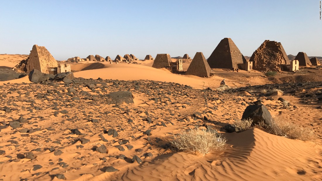 The landscape leading up the UNESCO World Heritage Site is dramatic, with sweeping sand dunes and clear skies.