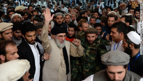 Hekmatyar gestures as he arrives at a rally in Jalalabad last week.