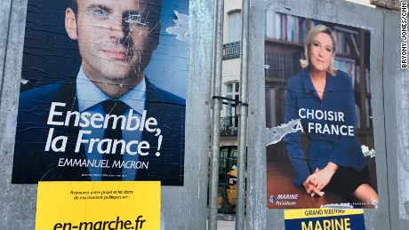 Election posters outside Beziers&#39; town hall is seen with Macron&#39;s eyes scratched out.