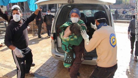 Members of Syria's White Helmets transport victims away from the scene.