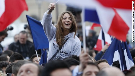 A supporter of Emmanuel Macron celebrates in front of the Louvre Museum in Paris on Sunday. 