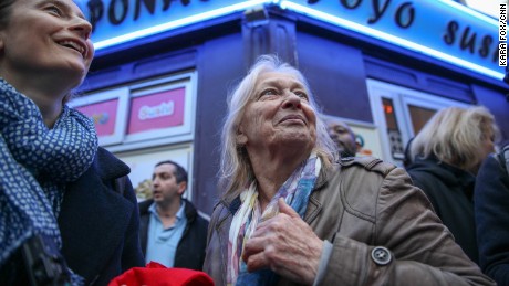 Sabine Gruhier (L), of Paris&#39; 15th district, gathers with her neighbors on the street outside Macron&#39;s headquarters moments before the polls close on election day.
