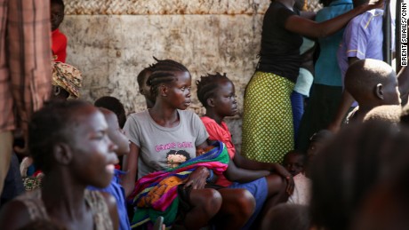 Blessing Akujo sits with her newborn daughter after fleeing her homeland of South Sudan, leaving her parents behind.