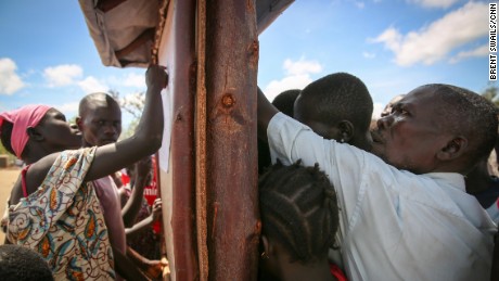 New arrivals search for their registration number at Uganda&#39;s Imvepi Refugee Camp. Once on the list, they can begin the process of settling on a plot of land and within five years, the hope is that they become self-sustainable.