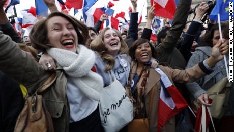 Female supporters of Macron celebrate the centrist&#39;s win front of the Louvre Museum in Paris on May 7.