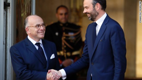 Philippe, right, shakes hands with outgoing Prime Minister Bernard Cazeneuve in Paris, Monday.