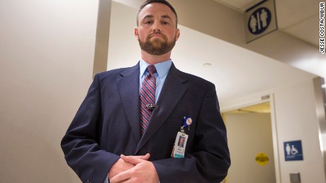 Ryan Curran of Massachusetts General Hospital in front of the bathrooms in the main lobby.