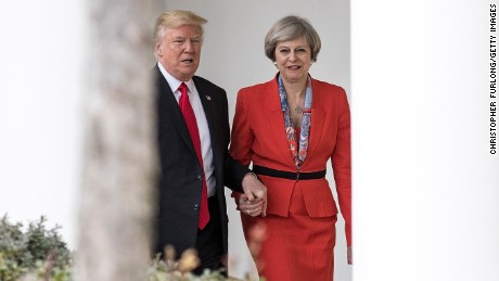 US President Donald Trump and UK Prime Minister Theresa May walk hand-in-hand at the White House on January 27, 2017.