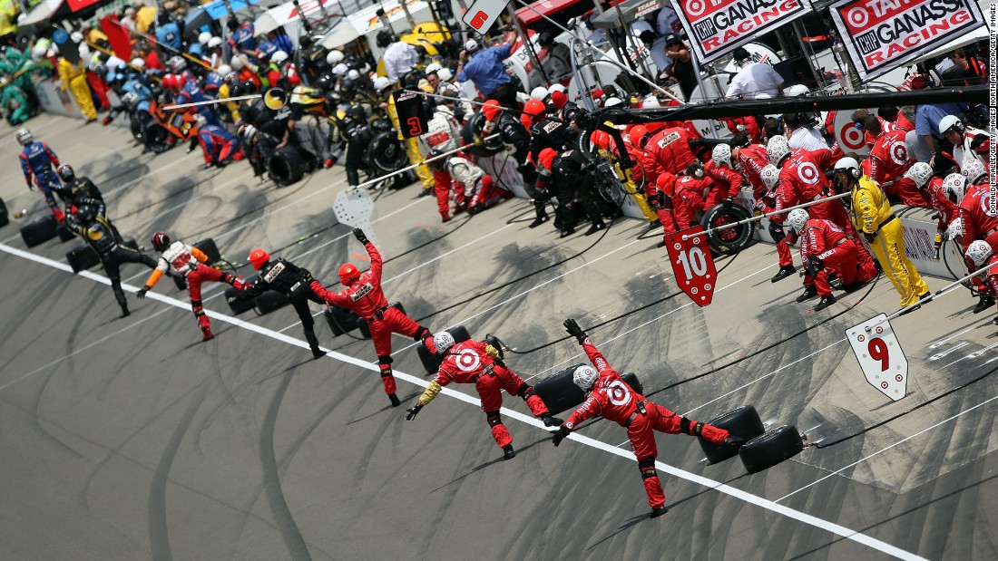 Pit crews direct their drivers at the 2008 Indy 500.