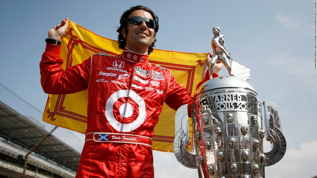 Scottish driver Dario Franchitti, who won the Indy 500 on three occasions, poses with the trophy at the Brickyard in 2010. 