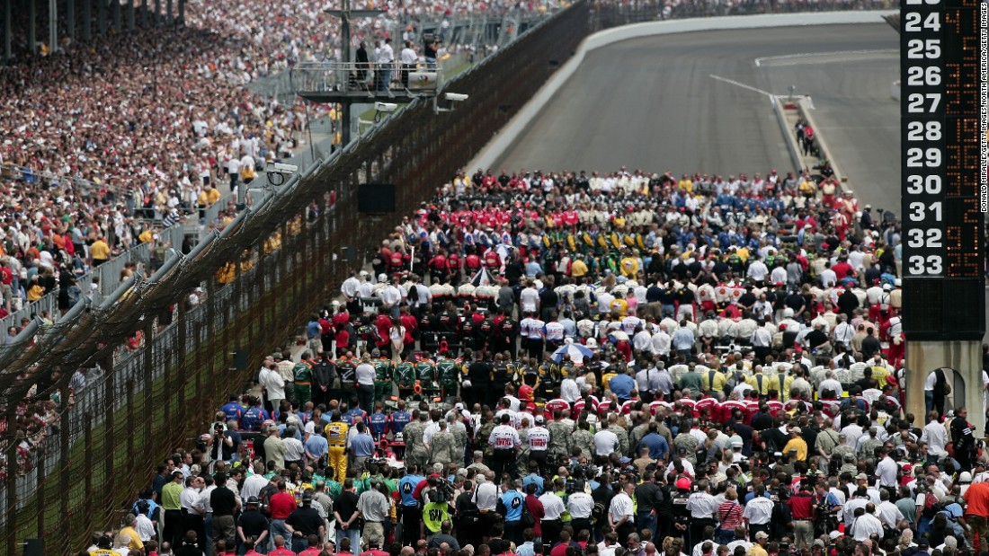 Drivers and their teams fill the track for the US national anthem in 2008.
