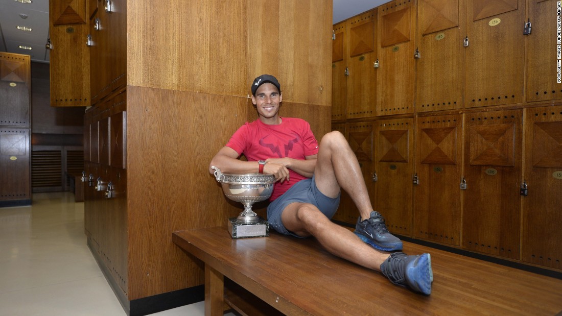 Rafael Nadal of Spain poses in the locker room with the Coupe des Mousquetaires trophy at Roland Garros in 2014.