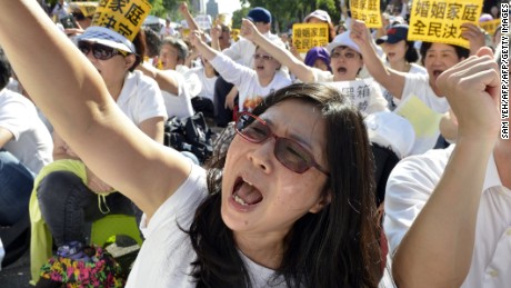 Protesters march against same-sex marriage outside the Parliament in Taipei on November 17, 2016.
