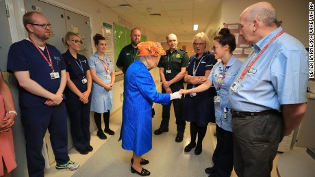 Queen Elizabeth II speaks with staff at the Royal Manchester Children&#39;s Hospital.