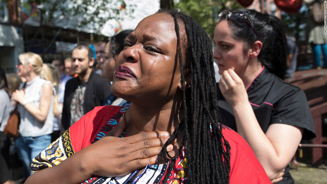 A women sheds tears after observing the minute of silence in St. Ann&#39;s Square.