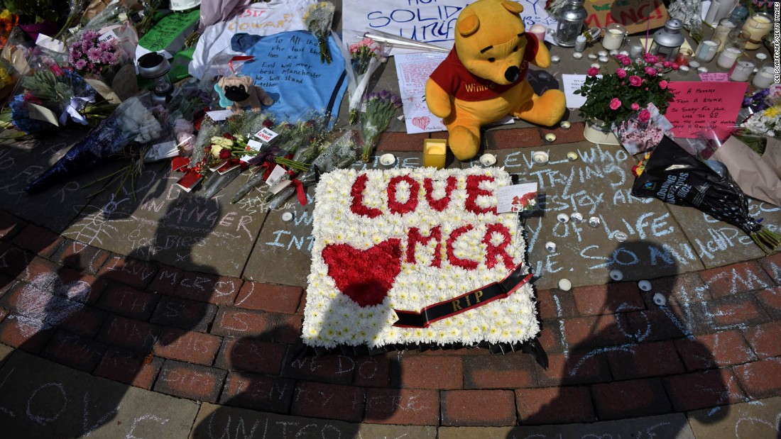 Flowers and tribute messages are left for victims in St. Ann&#39;s Square.