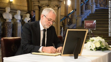 Labour leader Jeremy Corbyn signs a book of condolence at Manchester Town Hall on Tuesday.