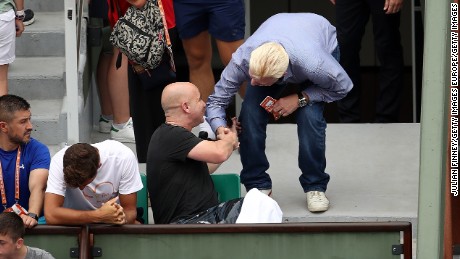 Andre Agassi (left), new coach of Novak Djokovic, speaks with Boris Becker on day two at Roland Garros