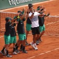 Djokovic  celebrates with the ball boys