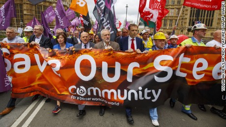 Corbyn (center) marches with demonstrating steelworkers in London in 2016. 