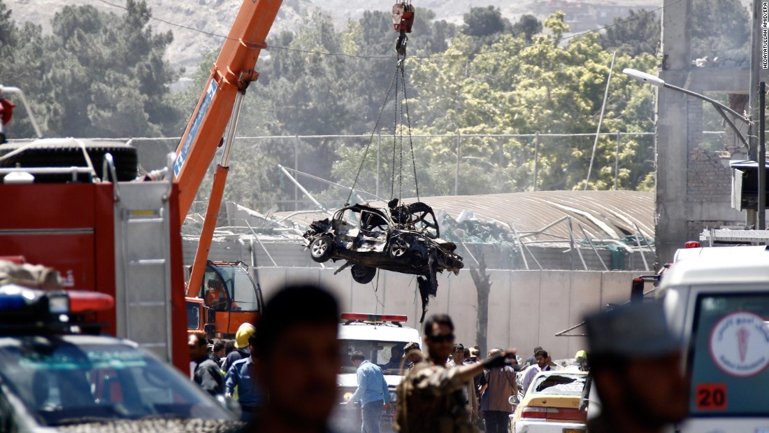 A mangled vehicle is lifted out of the wreckage after  the explosion.