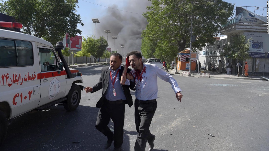 A wounded man is helped away from the scene of the attack, which struck in the midst of Kabul&#39;s morning rush hour. 