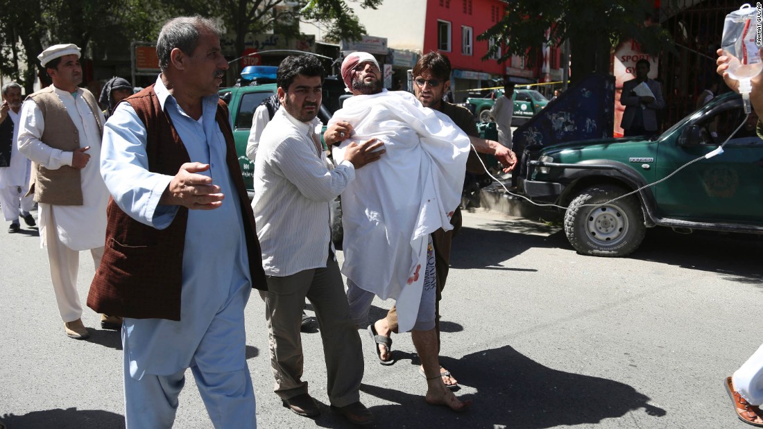 People help an injured man following the attack. 