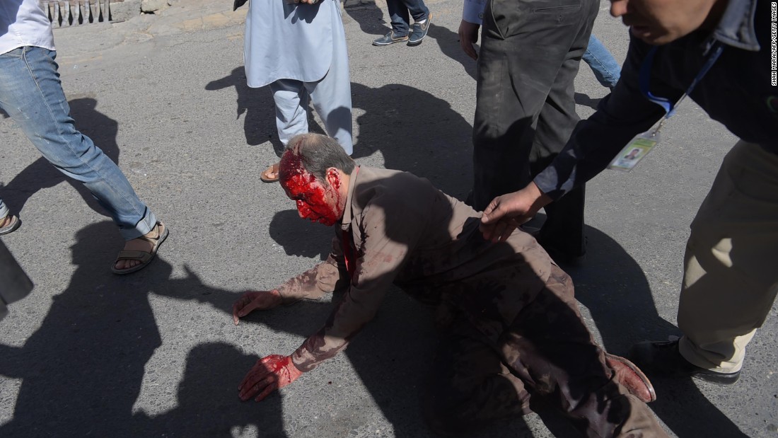 An injured man receives aid following the attack. 