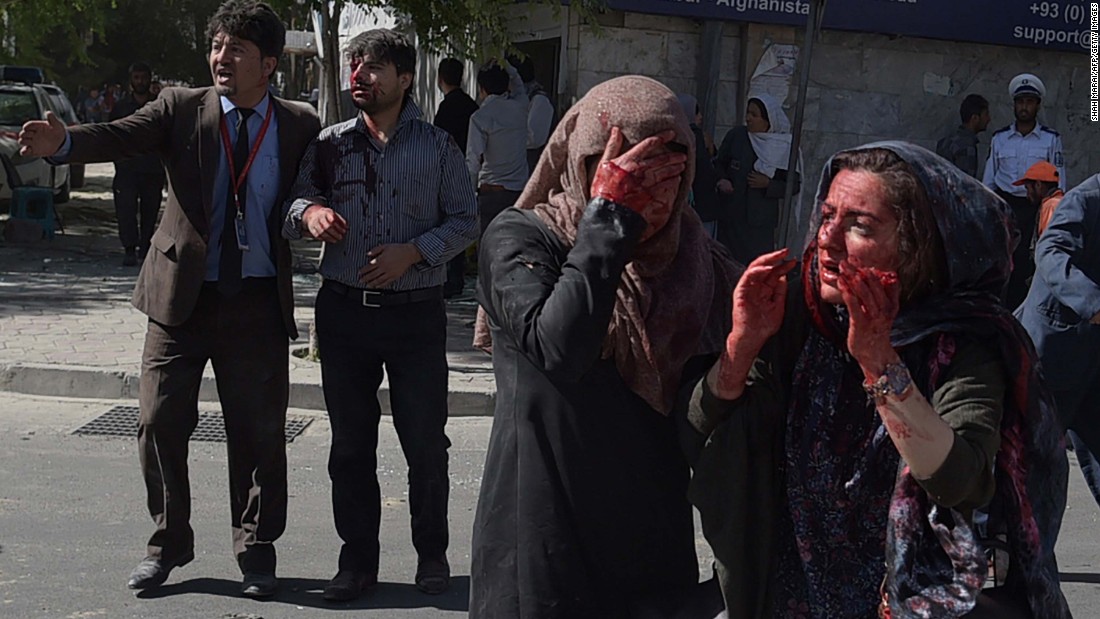 Women covered in blood stand dazed in the aftermath of the attack near Kabul&#39;s highly secure diplomatic area.