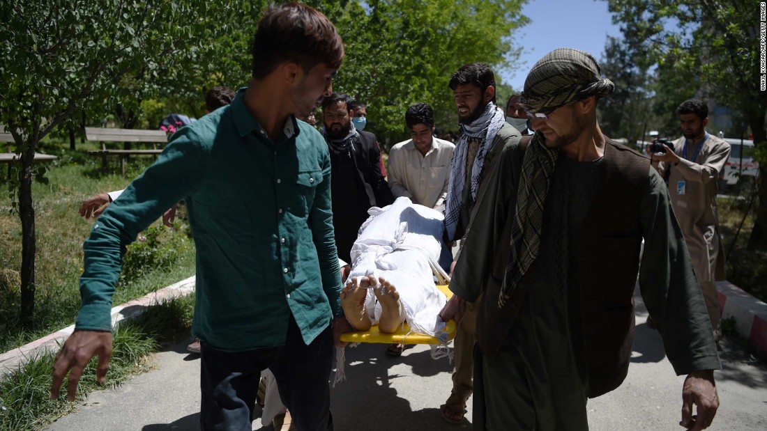 Volunteers carry the body of a victim to the Wazir Akbar Khan Hospital in Kabul.