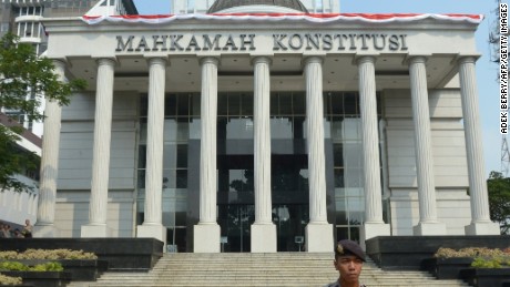 An Indonesian policeman stands guard outside the Constitutional Court in Jakarta in August 2014.