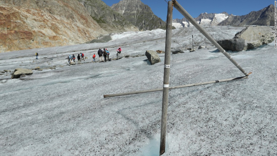 A wooden pole that had been driven into the ice the year before now stands exposed as the Aletsch glacier melts and sinks at a rate of about 10-13 meters per year near Bettmeralp, Switzerland. 