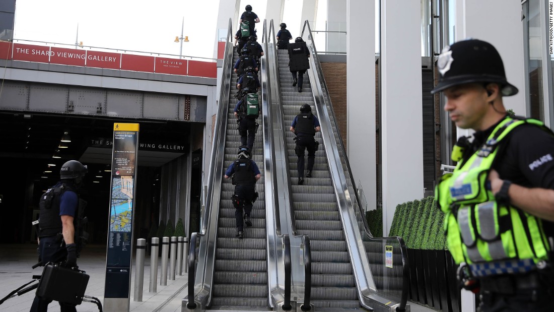 Counter terrorism officers move up an escalator under The Shard, an iconic highrise near the scene of last night&#39;s London Bridge attack.