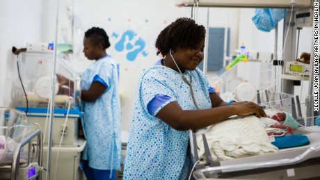 HINCHE, HAITI - APRIL 28, 2016: Thamar Julmiste, a nurse, attends to neonates in the Neonatal Intensive Care Unit at Hospital St. Therese in Hinche, Haiti. The neonate she is attending to was born the previous day, weighing .8 kg. He wasn't breathing when he was born (26 weeks), but they were able to recusistate him. She has worked at Hinche for three years.

5/9/16
WEB CAPTION: Nurse Thamar Julmiste (right), known for singing to her tiny patients, attends to a newborn in the Neonatal Intensive Care Unit at St. Thérèse Hospital in Hinche, Haiti.

5/15/16
FACEBOOK: "With more nurses knowing [how to handle these situations], we will save more children." - Nurse Thamar Julmiste
A free training program in Haiti to educate nurses in neonatal and pediatric intensive care: http://bit.ly/1Ns80pI

5/15/16
TWITTER: Neonatal and pediatric intensive care training in Haiti is helping nurses save lives: http://bit.ly/1Ns80pI

5/22/16
TWITTER: "With more nurses knowing [how to handle these situations], we will save more children." http://bit.ly/1Ns80pI

11/16/16
WEB CAPTION: Thamar Julmiste, nurse, Haiti
"I remember one nurse because she sang to the babies. She would belt out either Mariah Carey or Céline Dion."
"I was walking the hospital grounds in Hinche, a place a few hours outside of Port-au-Prince, and passed a small, narrow door. I opened it and was in this neonatal intensive care unit. It's air-conditioned, white, and pristine, and smells like a swimming pool. There were a ton of nurses in this tiny space, taking care of babies I remember one nurse because she sang to the babies. She would belt out either Mariah Carey or Céline Dion. Her name is Thamar Julmiste." - Cecille Joan Avila

1/21/16
TWITTER / FACEBOOK: [In grid w/ other photos] In clinics, on the doorsteps of homes, and at hospital bedsides, the women we've met are the backbone of health care in communities around the world. We're proud to stand beside them every step of the way. Read some o