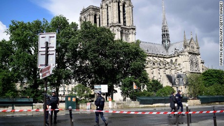 French police officials gather at a cordonned-off area at Notre-Dame Cathederal in Paris on June 6, 2017. 
A French police officer has shot and injured a man who attacked him with a hammer outside Paris&#39;s Notre-Dame cathedral authorities said. Police sealed off the area in front of the cathedral, where the attacker lay injured on the ground.
 / AFP PHOTO / Martin BUREAU        (Photo credit should read MARTIN BUREAU/AFP/Getty Images)