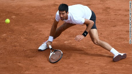 Serbia's Novak Djokovic returns the ball to Austria's Dominic Thiem during their tennis match at the Roland Garros 2017 French Open on June 7, 2017 in Paris.  / AFP PHOTO / Eric FEFERBERG        (Photo credit should read ERIC FEFERBERG/AFP/Getty Images)