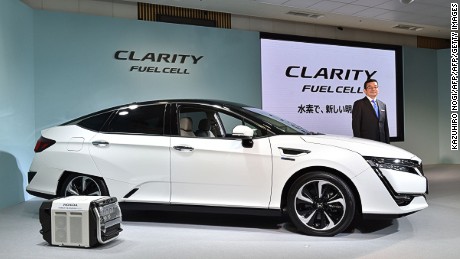 Honda Motors President Takahiro Hachigo poses with its new fuel cell vehicle (FCV), the Clarity Fuel Cell during a press preview at the company&#39;s headquarters in Tokyo on March 10, 2016. 
Honda Motor announced on March 10 that they will began sales in Japan of its all-new Clarity Fuel Cell. / AFP / KAZUHIRO NOGI        (Photo credit should read KAZUHIRO NOGI/AFP/Getty Images)