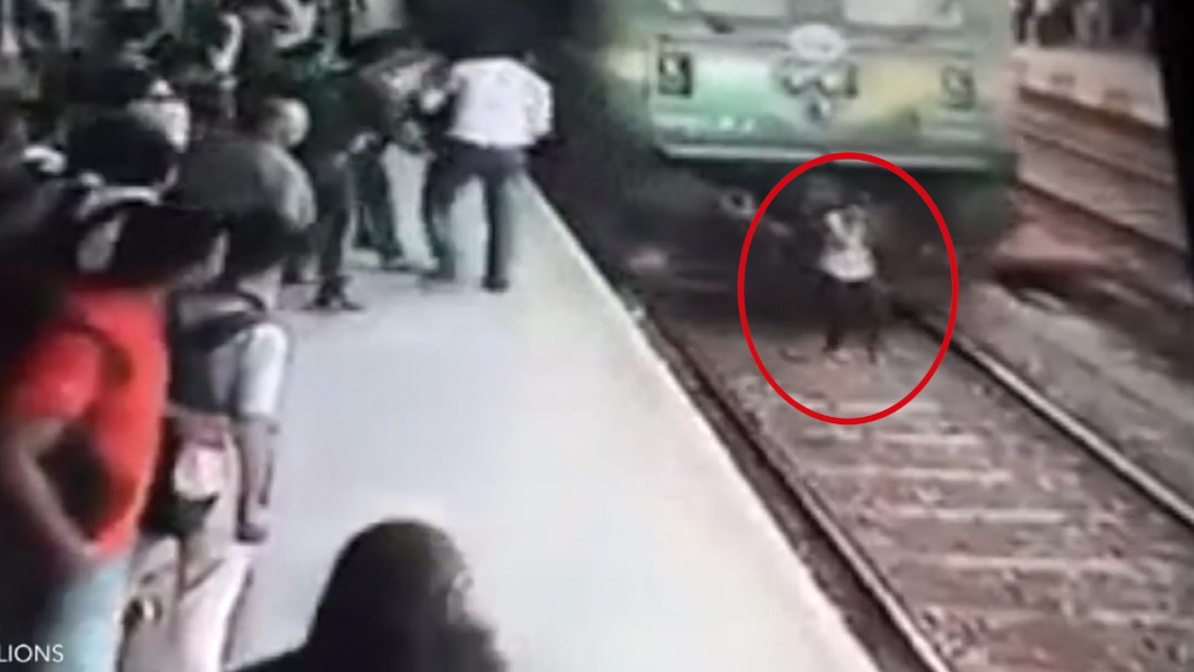 Distracted woman gets run over by train - CNN Video