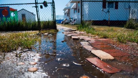 Sea water collects in front of a home in Tangier, Virginia, in May 2017. Tangier Island in Chesapeake Bay has lost two-thirds of its landmass since 1850. Now, the 1.2 square mile island is suffering from floods and erosion and is slowly sinking. A <a href="https://www.nature.com/articles/srep17890" target="_blank" target="_blank">paper</a> published in the journal Scientific Reports states that "the citizens of Tangier may become among the first climate change refugees in the continental USA."