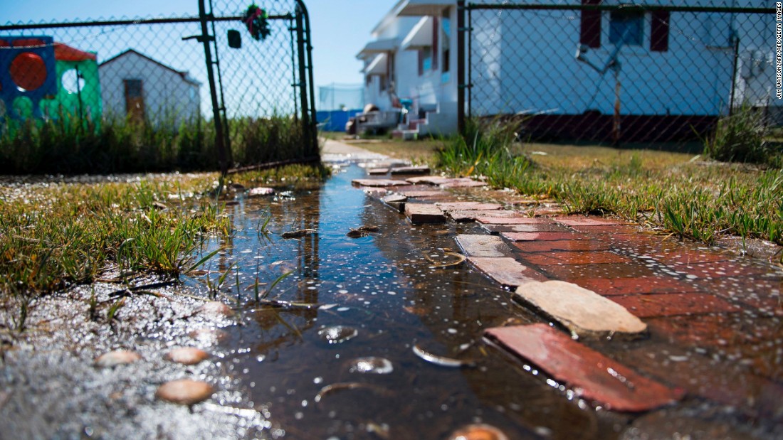 Sea water collects in front of a home in Tangier, Virginia, in May 2017. Tangier Island in Chesapeake Bay has lost two-thirds of its landmass since 1850. Now, the 1.2 square mile island is suffering from floods and erosion and is slowly sinking. A &lt;a href=&quot;https://www.nature.com/articles/srep17890&quot; target=&quot;_blank&quot;&gt;paper&lt;/a&gt; published in the journal Scientific Reports states that &quot;the citizens of Tangier may become among the first climate change refugees in the continental USA.&quot;