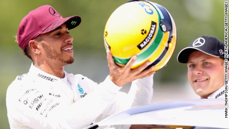 Lewis Hamilton was presented with one of Ayrton Senna&#39;s race helmets after equaling the Brazilian&#39;s tally of 65 career poles. 