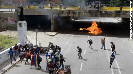 Opposition demonstrators clash with riot police during the "Towards Victory" protest against the government of Nicolas Maduro, in Caracas on June 10, 2017. Clashes at near daily protests by demonstrators calling for Maduro to quit have left 66 people dead since April 1, prosecutors say.