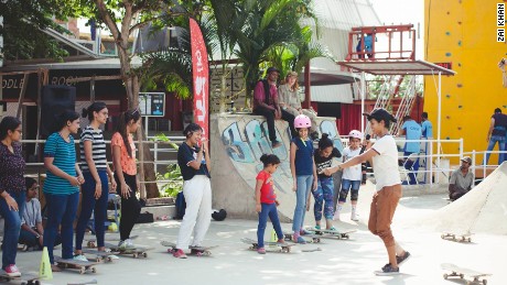 During a workshop, Verghese teaches kids how to skateboard.