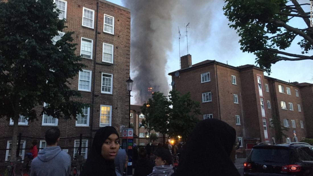 Smoke could be seen billowing over the heads of residents who gathered in nearby streets to watch the blaze.