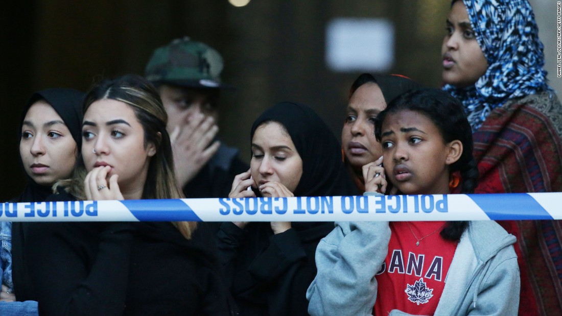 People watch as Grenfell Tower is engulfed by fire.